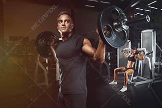 Young and fit couple in the gym doing workout