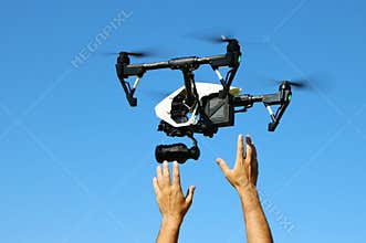 Hands Catching Flying Camera Drone