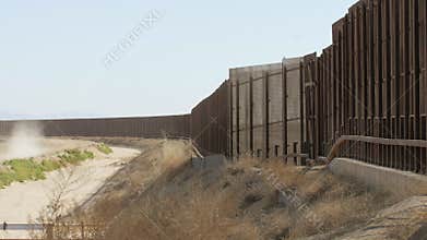 Slow Pan of Border Fence Between the US and Mexico