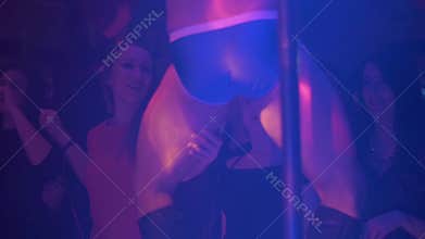 Back side boy in blue boxers wave hips in front girls in nightclub. Slow motion