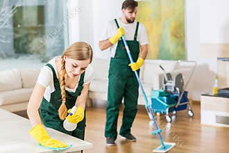 Cleaners putting in order dirty apartment