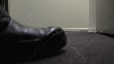 Man walks out of a door into a corridor at night