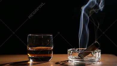 Whiskey drinks with smoking cigars