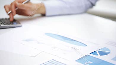 Busy businessman with laptop and papers in office