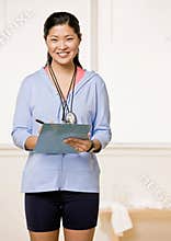 Personal trainer holds clipboard