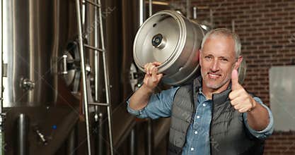 brewery worker holding a beer barrel