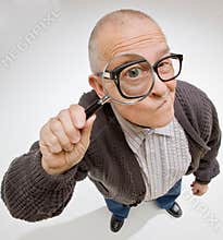 Man peering through magnifying glass