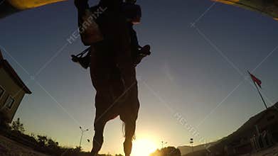 Horse jumping hurdle at sunset, silhouette rider