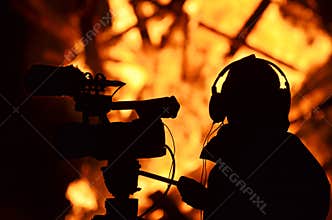 Cameraman reporter journalist filming building on fire flames