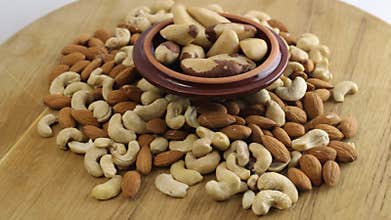 Pile of almonds, cashews and brazilian nuts spinning slowly and smoothly