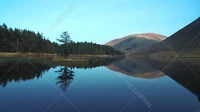 Beautiful footage of still lake and mountains against sky