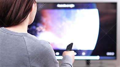 Smart tv and woman pressing remote control
