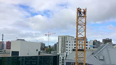 Time lapse of builders assemble a tower crane
