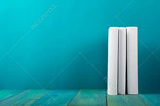 Row of colorful books, grungy blue background, free copy space V
