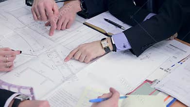 Group engineers and architects discuss the blueprint.