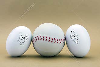 Two eggs look missed at a baseball ball