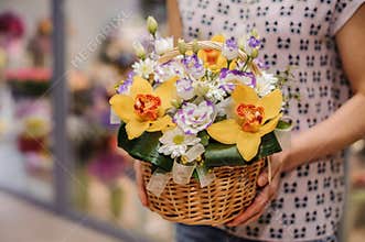 Colorful bouquet with different flowers in hands