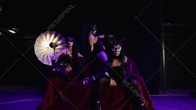 Photoshoot wearing masks in the style of Burlesque