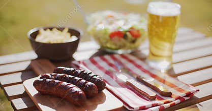 Grilled sausages and salads for a summer picnic