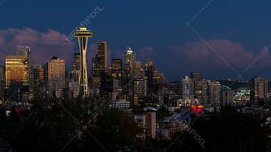 Tume lapse of clouds and night lights over cityscape of Seattle Washington from sunset to blue hour and night 4k uhd