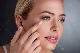 Middle age woman checking her face