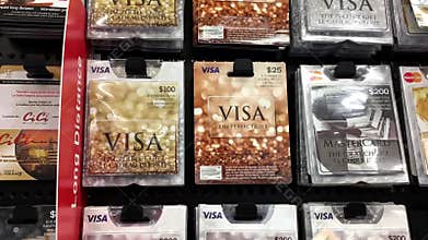 Woman picking twenty five dollars Visa gift card