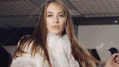 Closeup of women flirting seductive in rich fur coats. Slowly