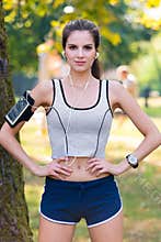 Female Runner Wearing Earphones and Armband