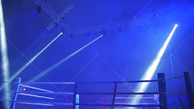 Boxing ring in lights of projectors before fight night