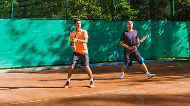 Coaching or teaching play tennis on a court outdoor. Training of professional sports players