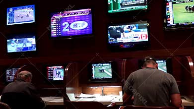 People playing horse racing gambling game inside Hard Rock Casino