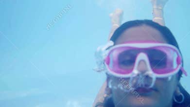girl in bikini diving in pool