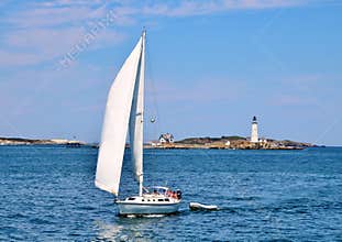 Yacht Sailing in front of Boston Harbor Lighthouse