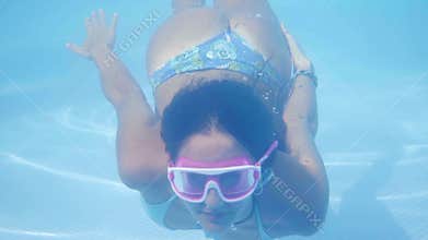 girl in bikini diving in pool
