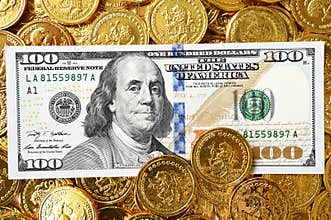 One hundred dollar and coins