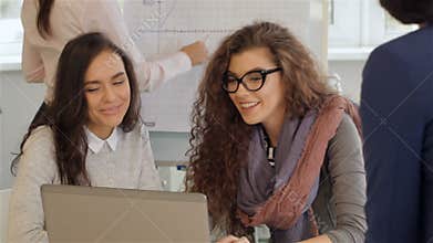 Creative team of four women work actively at the office