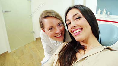 Close up of happy female patient with dentist