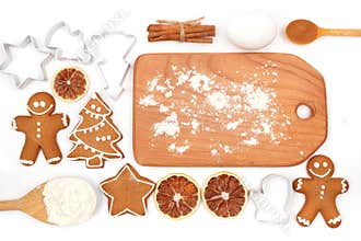 Creative winter time baking background. Kitchen utensils and ingredients for christmas homemade gingerbread cookies on white