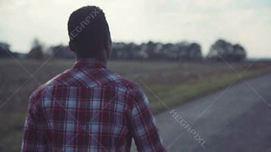 Black man going straight on countryside road