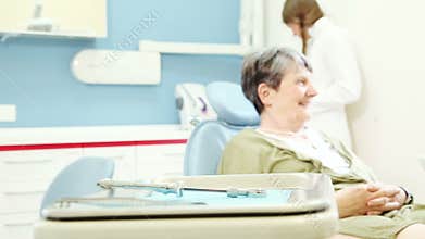 Zoom in view of elderly female patient sitting in dental chair