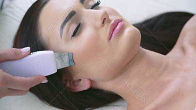 Close up of smart woman on procedure in beauty parlor