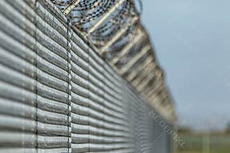 Barbwired fence suggesting illegal immigration
