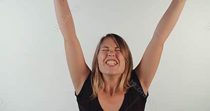 Young blond woman acting surprised and happy
