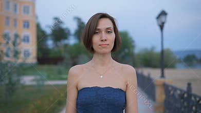 Portrait of a young, attractive woman in the street.