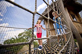 Brother and sister on rope ladder