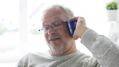 Happy senior man calling on smartphone at home 25