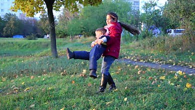 Older sister spinning his younger brother
