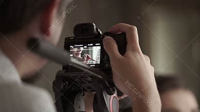 Man shooting on mirrorless camera woman`s makeup