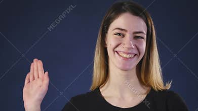 Pretty waves a hand against a dark background