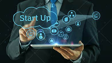 Business man pointing on start up concept tablet pad black